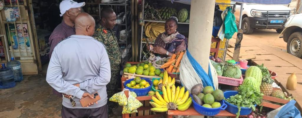 #htmlcaption-8 The Deputy Coordinator OWC Brig.Gen. GK Muwanguzi visits a PDM beneficiary Ms. Kendagano Imelda at her fresh foods stall.